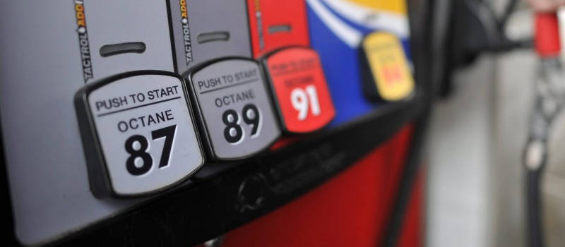 Close up photograph of fuel pump at a gas station displaying the different octane grades available.